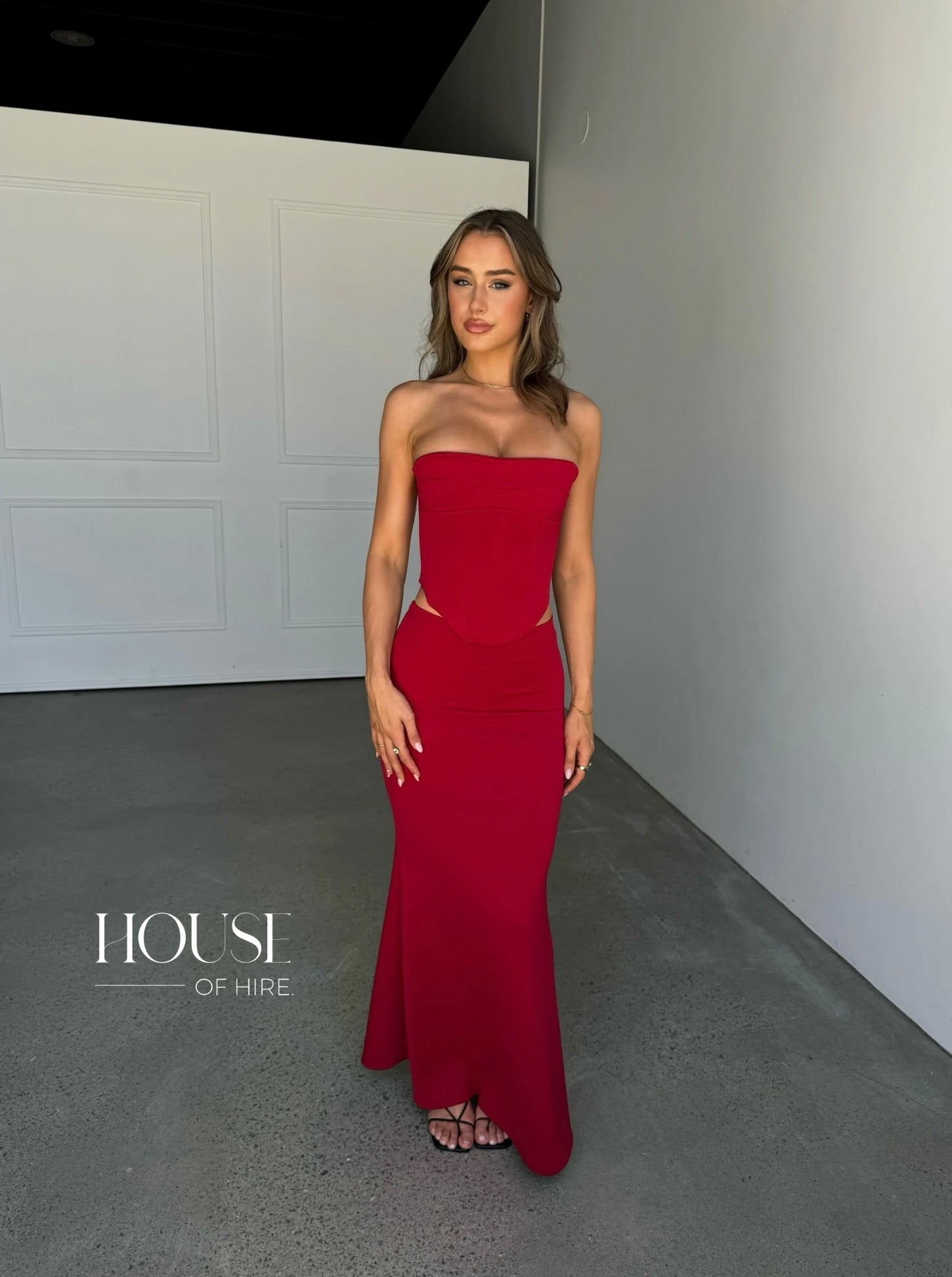 hntr the label red corset dress hntrthelabel louie gown in wine Description: INTRODUCING THE LOUIE GOWN, A STUNNING TWO-PIECE GOWN. FEATURING A STRUCTURED CORSET TOP AND MAXI SKIRT CRAFTED FROM LUXURIOUS BUTTERY FABRIC, THIS GOWN COMBINES STYLE